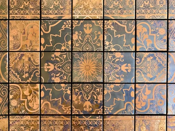 Amber and charcoal patterns with an aged-metal appearance. Watch the surface catch the light.
